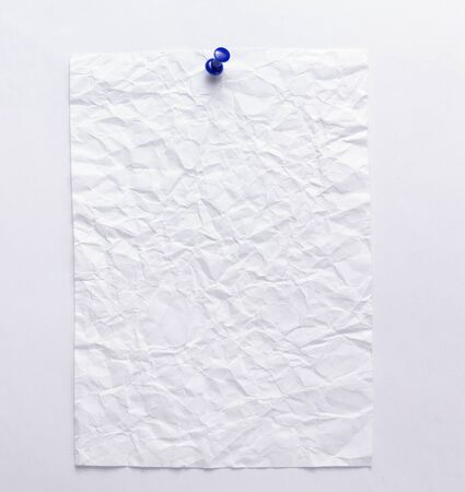 pinned sheet of paper at white background textureの写真素材