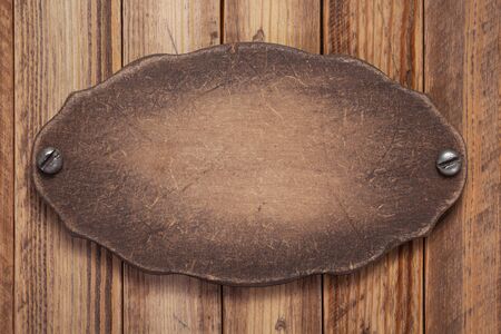 nameplate or wall sign board at wooden background texture surface with screwsの写真素材