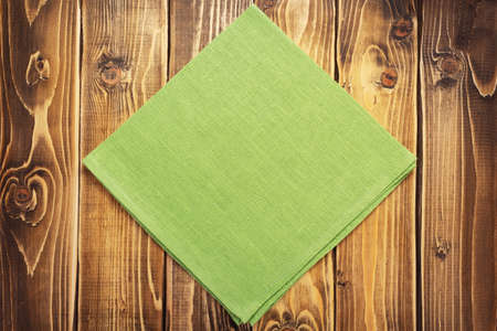cloth napkin on at rustic wooden plank board table background, top view