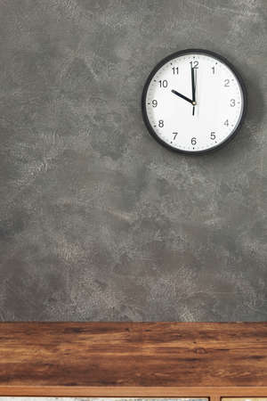 wall clock at concrete  or painted background, grey stone texture surface