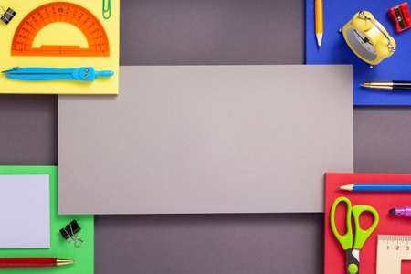 school accessories and office supplies at abstract colorful paper background