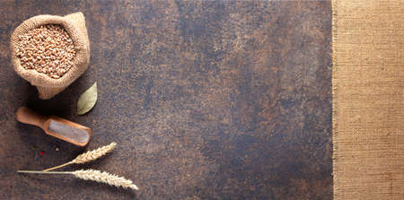 Bakery ingredients for homemade bread baking on table. Wheat grain food as panoramic top view at...