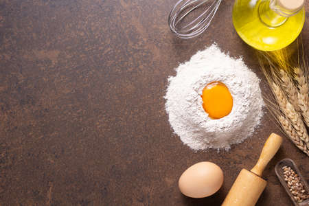 Bakery ingredients for homemade bread baking on table. Flour food and egg for recipe top view at...