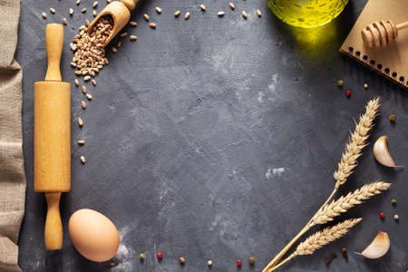 Bakery ingredients for homemade bread baking on table. Food recipe top view at stone background...