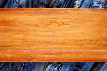 Denim jeans on old wooden background texture table surface. Top viewの写真素材