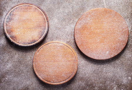 Scatterd flour powder food and pizza cutting board as bakery concept for homemade bread baking on...