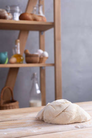 Wheat dough at flour powder on table for homemade bread cooking or baking. Food set at wooden...