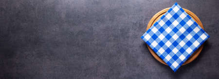 Pizza or bread cutting board and cloth napkin for homemade baking on table. Food recipe concept at...