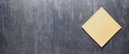 Folded  tablecloth at stone surface of table. Top view as panorama of cloth napkin texture background with copy spaceの写真素材