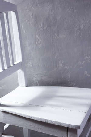 Old retro white wooden chair near concrete wall background. Miimalism concept of room interiorの写真素材