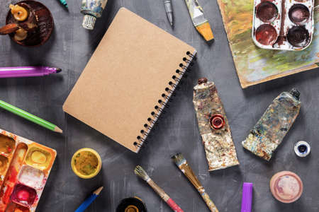 Paintbrush and tubes with painter tools at abstract table background texture. Art painter concept...