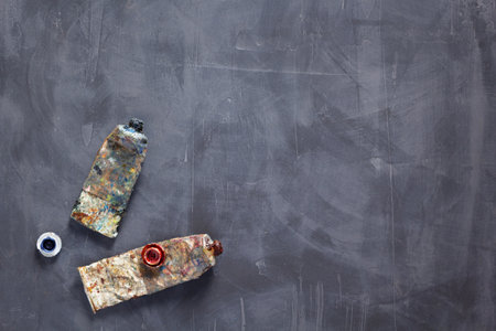 Used paint tubes as painter tools at table background texture. Art painter concept and paint brushの写真素材