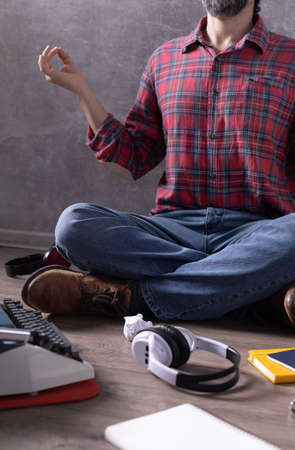Man meditating on floor thinking idea or relaxing.