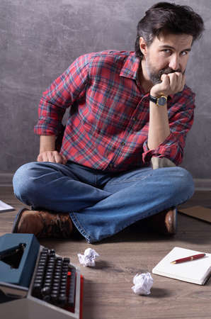 Man sitting on floor thinking idea.