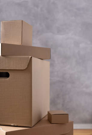 Stack of cardboard box near wall background. Cardboard boxes for moving to new home. Relocation...