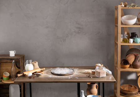Wheat flour powder and pizza board for homemade bread cooking or baking on table.