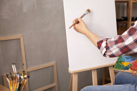 Male artist working on painting. Man artist painter in creative studio as art conceptの写真素材