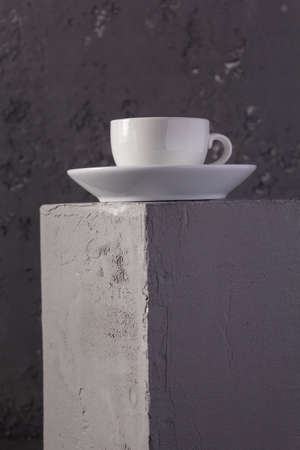 Empty cup of coffee on concrete grey cube as  background texture.  Abstract concept of break coffee...