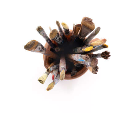 Paint brush in clay jug for art painting isolated on white background. Paintbrush for oil painting...