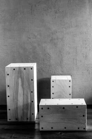 Stack of wooden cube or plywood box block near wall background texture. Abstract construction concept of minimalism designの写真素材