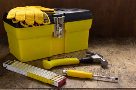 Construction tools and toolbox on wooden tablel background texture. Tools kit and tool boxの写真素材