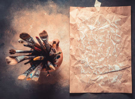 Paint brush as art painter tool on abstract background texture. Paintbrush for painting and piece of paper as artistic paint still life. Abstract art conceptの写真素材