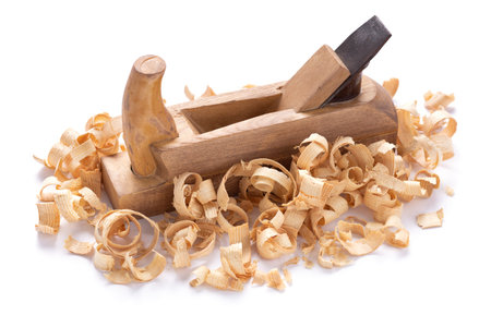Plane tool for carpenter or joiner and wood shavings isolated on white background. Woodworking tools...