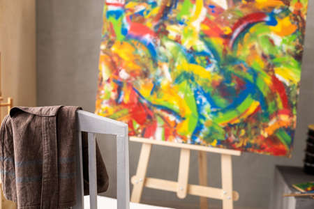 Chair and oil painting. Art still life and paintbrush painting in artist creative studio with...