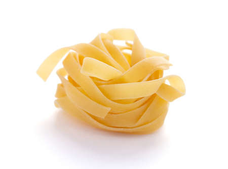 Pasta tagliatelle isolated on white background. Raw fettuccine pasta  italian food at whiteの写真素材