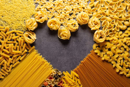 Pasta collection food on table background. Raw pasta assortment at stone tabletopの写真素材
