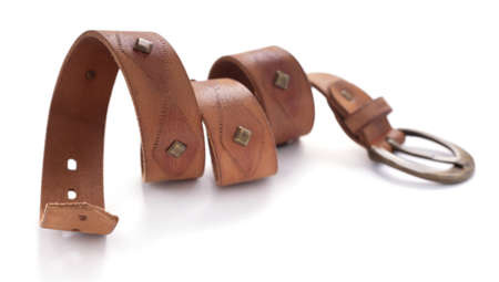Brown leather belt isolated on white background. Old shabby beltの写真素材