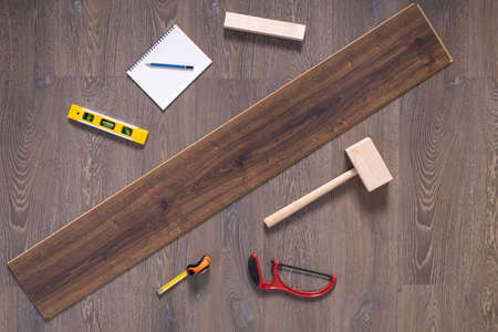 Wood laminate floor and tools background texture. Wooden laminate floor with tool