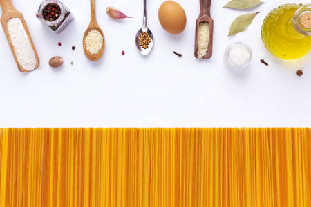 Raw pasta spaghetti and ingredients food on white background. Pasta recipe conceptの写真素材