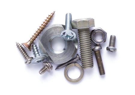 Set of old metal screw, bolt head, nut, washer and spring washer tool isolated on white background