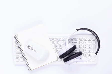Wireless computer keyboard and mouse with notebook on white background. Modern office conceptの写真素材
