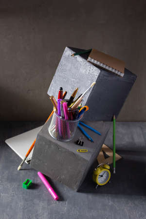 Back to school concept on table. Study supplies and accessories on concrete cube backgroundの写真素材