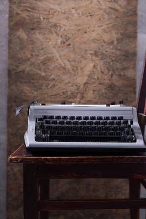 Vintage old typewriter at wooden desk table. Writer or screenwriter creative conceptの写真素材