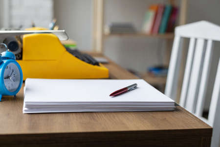 Stack sheet of paper and vintage old typewriter at wood desk table. Writer or study creativeの写真素材