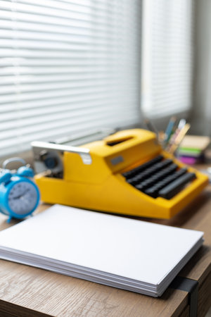 Stack sheet of paper and vintage old typewriter at wood desk table. Writer or study creativeの写真素材