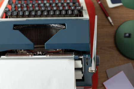 Vintage old typewriter at wooden desk table. Writer or screenwriter creative conceptの写真素材