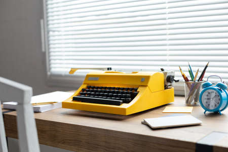 Vintage old typewriter at wood desk table. Writer or study creative concept