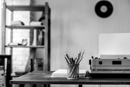 Stack of paper and vintage old typewriter at wooden desk table. Writer or screenwriter creative conceptの写真素材