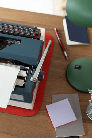 Vintage old typewriter at wooden desk table. Writer or screenwriter creative concept