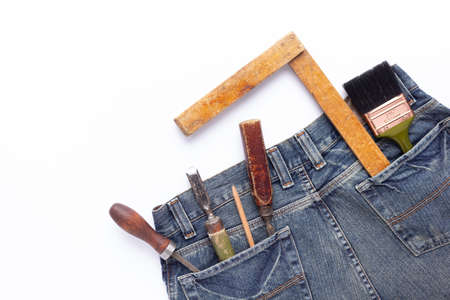Kit of woodwork tools in jeans pocket at white background. Woodworking conceptの写真素材