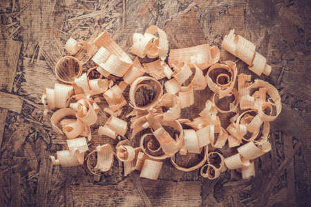 Wood shavings on table background. Wooden shaving at old plank board textureの写真素材