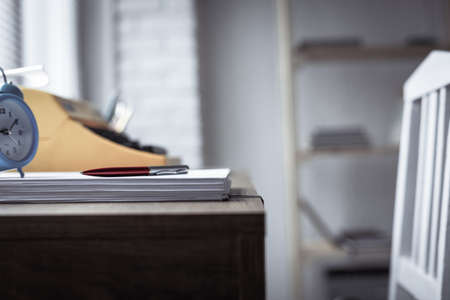 Stack sheet of paper and vintage old typewriter at wood desk table. Writer or study creativeの写真素材