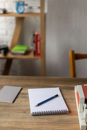 Notebook and vintage old typewriter at wooden desk table. Writer or screenwriter creative concept