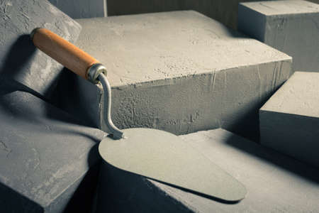 Concrete cube or construction brick and trowel. Construction concept and masonの写真素材