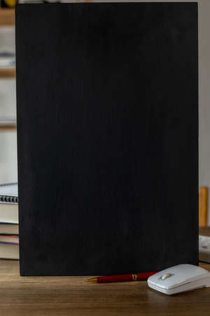 Chalkboard and school supplies at table. Student home workplace