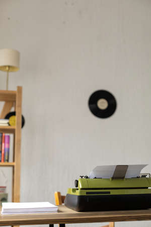 Vintage old typewriter at wooden desk table. Writer or screenwriter creative concept